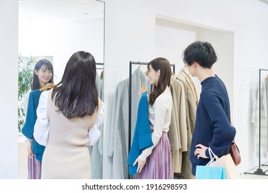 Asian Couple Enjoying Shopping At The Clothing Shop