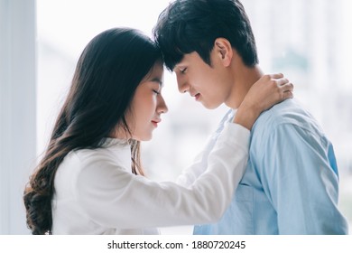 Asian couple happily embracing each other
