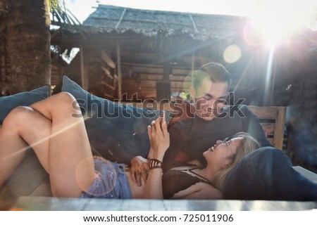 asian couple happy together in the bar on the beach