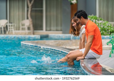 Asian Couple Have Goodtime Together On Summer Vacation At Pool Side In Hotel And Resort