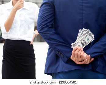 Asian Couple Having Financial Problems. Man Wearing Blue Suit Hide Money Behind. Woman Suspicious Of Hidden Behaviors. Lying Will Break Relationship Between Couple.