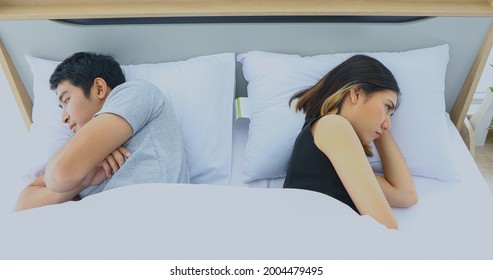 Asian Couple Having Problem In Bed And Frustrated Couple With Serious Problems And Not Talking Feeling Offended Or Stubborn