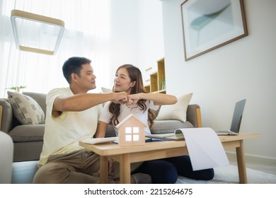 Asian couple in home or house. To bump punch, compare prices, interest, credit and calculate together. Include laptop, calculator and document on table. Concept for marriage, family, loan, finance.
 - Shutterstock ID 2215264675
