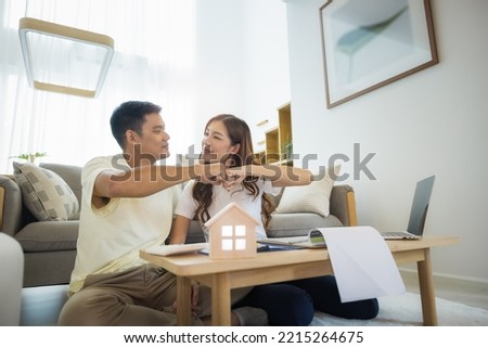 Asian couple in home or house. To bump punch, compare prices, interest, credit and calculate together. Include laptop, calculator and document on table. Concept for marriage, family, loan, finance.
