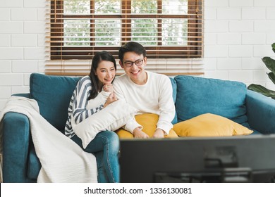 Asian couple lifestyle, man and woman watching TV movies at home, family lifestyle relax and recreation concept