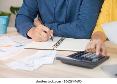 Asian Couple List Home Financial Bill Budget On Table In Kitchen At New House.family Expense