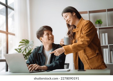 Asian couple looking laptop with happy together in the home. Success of lovers in front of a notebook. Happy couple on social online with a laptop. - Shutterstock ID 2278090191