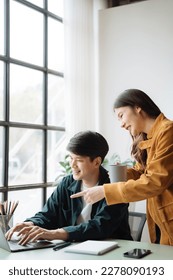 Asian couple looking laptop with happy together in the home. Success of lovers in front of a notebook. Happy couple on social online with a laptop. - Shutterstock ID 2278090193