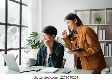 Asian couple looking laptop with happy together in the home. Success of lovers in front of a notebook. Happy couple on social online with a laptop. - Shutterstock ID 2278090209