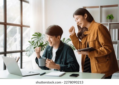 Asian couple looking laptop with happy together in the home. Success of lovers in front of a notebook. Happy couple on social online with a laptop. - Shutterstock ID 2278090213