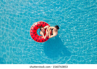 Asian Couple In Love In Swimming Pool On Summer Time, This Image Can Use For Valentine Day, Resort, Relax, Hotel, Water Sport And Spa Concept