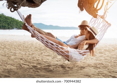 Asian Couple Lying On Hammock On Beach Thailand