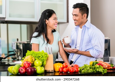 Asian Couple, Man And Woman, Cooking Food Together In Kitchen And Making Coffee