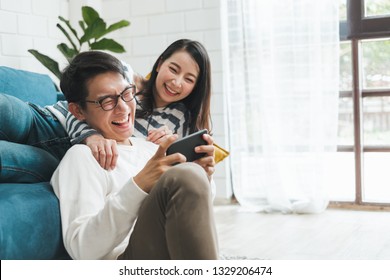 Asian couple man and woman talking working  spend time together at home, Asian couple family lifestyle concept