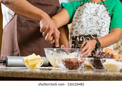 Asian Couple, Man And Women, Baking Homemade Cake In His Kitchen For Dessert