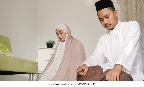 Asian Couple Praying Together At Home