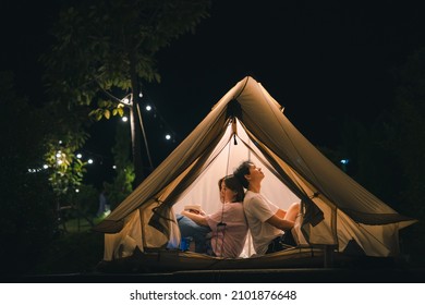 Asian Couple Relax In Camping Tent On Summer Vacation