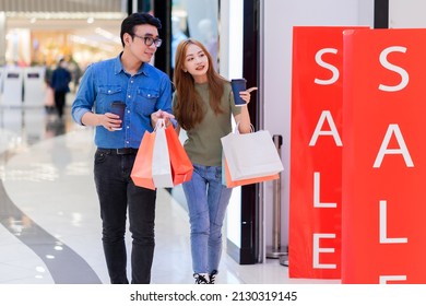 Asian Couple Shopping At The Mall
