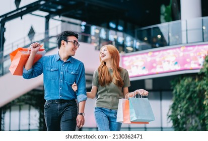 Asian Couple Shopping At The Mall