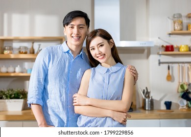 Asian Couple Smile To You In The Kitchen At Home