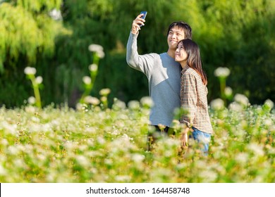 Asian Couple Take Photo By Mobile Phone