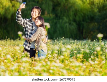 Asian Couple Take Photo By Mobile Phone 