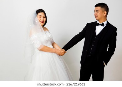 Asian Couple Taking Wedding Photo In Studio