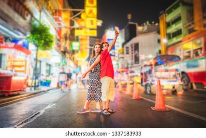 Asian Couple Tourist Taking Photo In Yaowarat Walking Street, Two People Traveler Selfie With Smartphone In Chinatown, Landmark Travel Bangkok Thailand China Town Night Light, Tourism Destination Asia