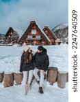 Asian Couple tourist travelling  Shirakawago village with white snow, Japan  Winter Season