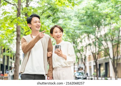 Asian Couple Using A Smartphone