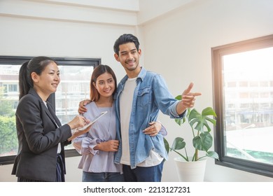 Asian Couple In Vacant Rental Apartment With Property Agent Looking For Room To Relocation