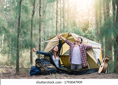 An Asian Couple Waking Up In The Morning While Camping In Forest In Summer Time