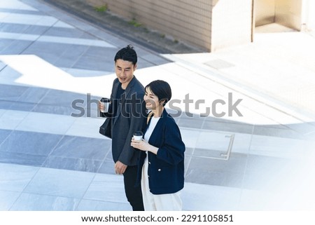 Asian couple walking in the city street.