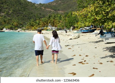 Asian Couple Walking On A Beach, Holding Hands