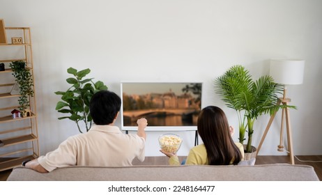 Asian couple watching tv together relaxing at home Enjoying Watching Television. - Shutterstock ID 2248164477