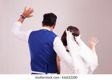 Asian Couple Waving Goodbye Pose. Studio Photography