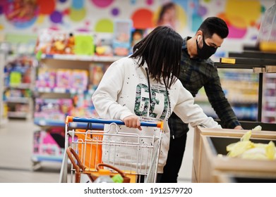 Asian Couple Wear In Protective Face Mask Shopping Together In Supermarket During Pandemic.