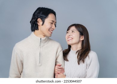 Asian couple wearing matching clothes in natural colors. Couple photo. Bridal photo. - Powered by Shutterstock