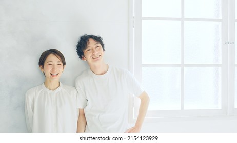 Asian couple in a white room. Refreshing lifestyle.