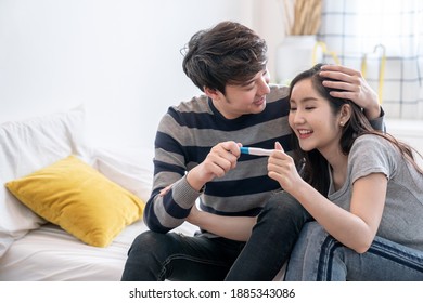 Asian Couples Are Happy To See The Results Of Their Pregnancy Test.