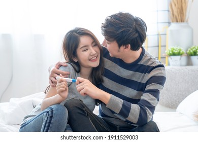 Asian Couples Are Happy When They See Pregnancy Test Results.