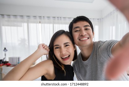 Asian Couples Smile and Look at Mobile Cameras for Selfies And Asian couples have to stay home during the coronavirus epidemic.