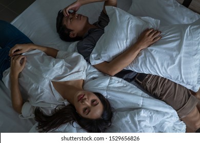 Asian couples are very stressed. they are in bed thinking