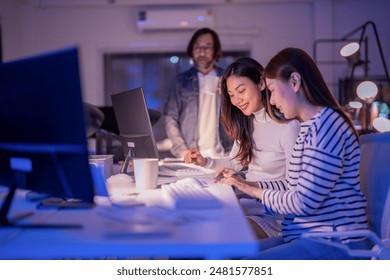 asian creative colleagues having a late-night meeting in the modern interior office space Diverse Team casual discuss brainstorm ideas sharing Working Late in Modern Office smart casual attire office - Powered by Shutterstock