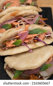 Asian Cuisine. Closeup View Of Pulled Pork Baos Buns With Vegetable Sand Sauce.