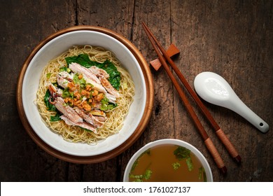 Asian Cuisine, Egg Noodles With Crab Meat And Soup Top View On Wooden Table.