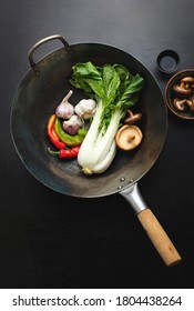 Asian Culinary Ingredients In A Wok Standing On Dark Surface, Asian Food Cooking Concept, Top Down View