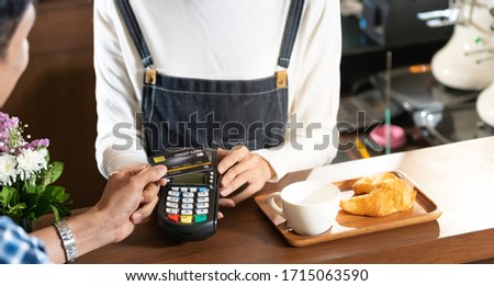 Asian customer using contactless credit card nfs technology pay to barista at cafe bar. Contactless payment preventing from coronavirus covid-19 Spreading and infection, Panoramic web banner crop.