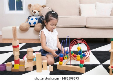 Asian Cut Kid Playing Wooden Blocks In Living Room