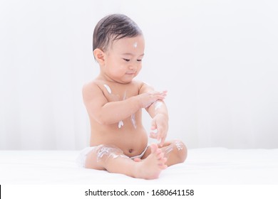 Asian cute baby applying moisturizing cream baby lotion,Childhood baby health  care and skin care concept.